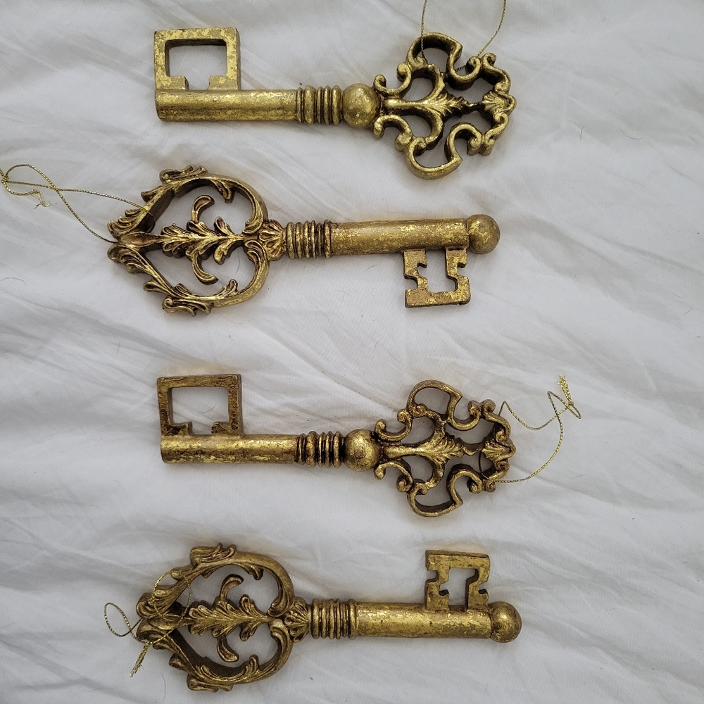 4 gold painted nutcracker style antique key Christmas ornaments.